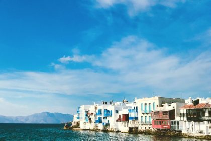white concrete houses near body of water