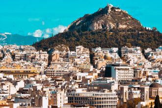 city buildings near mountain under blue sky during daytime