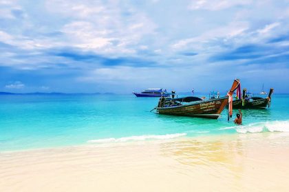 two brown boats on seashore