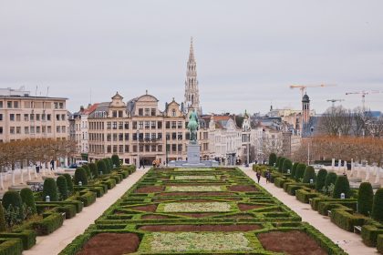 green grass field near brown concrete building during daytime