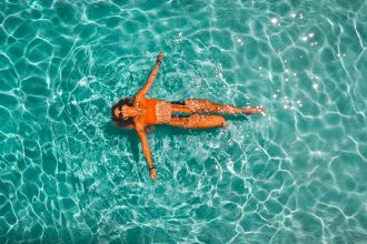 woman swimming alone in body of water