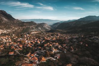 aerial photography of village surrounded by mountains
