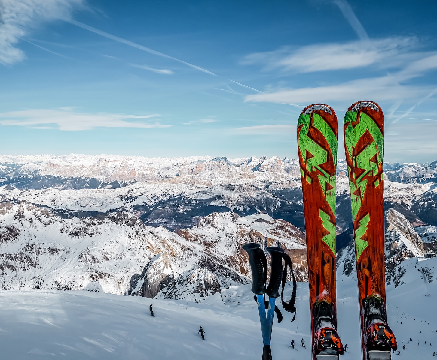 person in black pants and blue snow ski blades standing on snow covered mountain during daytime