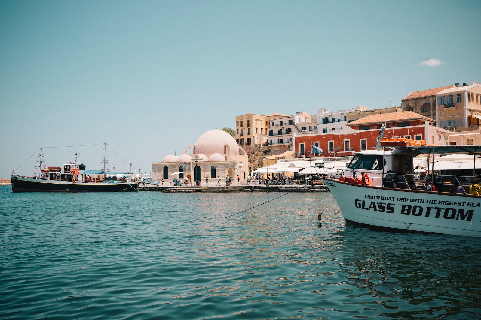 a boat in the water near a city
