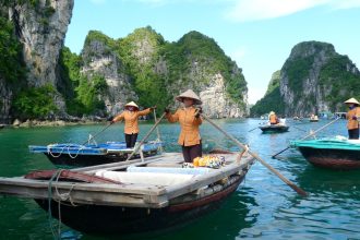 man in brown shirt and blue denim jeans riding on boat during daytime