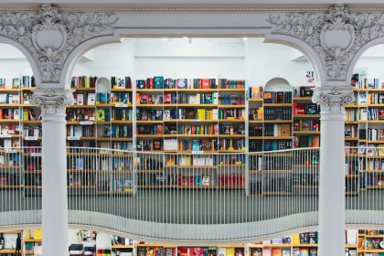books on white wooden shelf