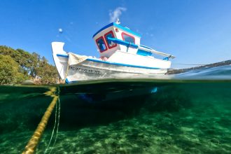 a boat in the water with a rope in the foreground