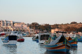 a group of boats floating on top of a body of water