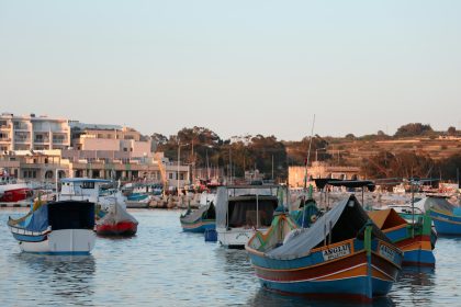 a group of boats floating on top of a body of water