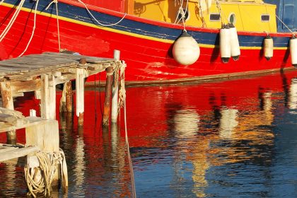 red and white boat on water