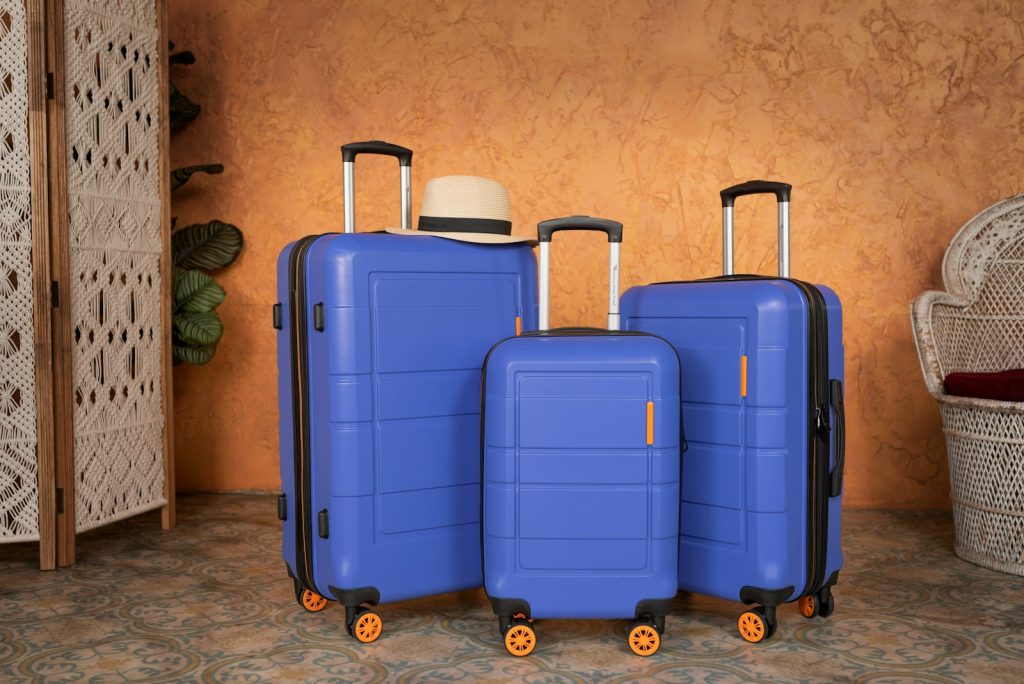 three pieces of blue luggage sitting next to each other