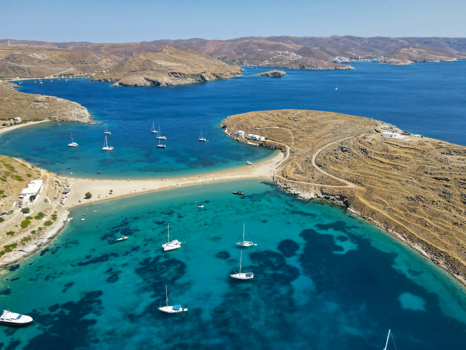 a body of water with boats in it and land around it