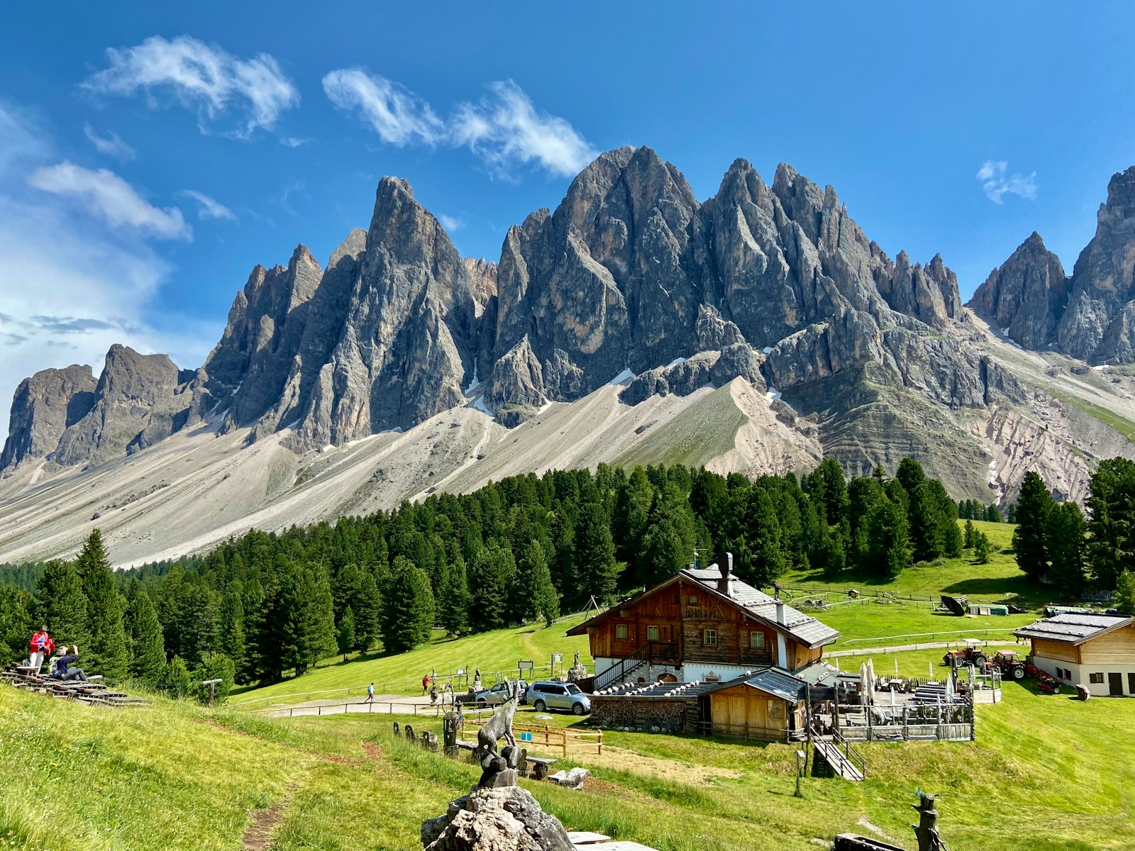 a mountain range with a small cabin in the foreground