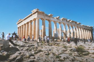 people near ancient structure during daytime